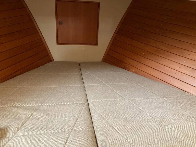 Slide: The Image of Interior cabin of 1985 Grand Banks 42 Classic with wooden paneling and twin beds. - 21