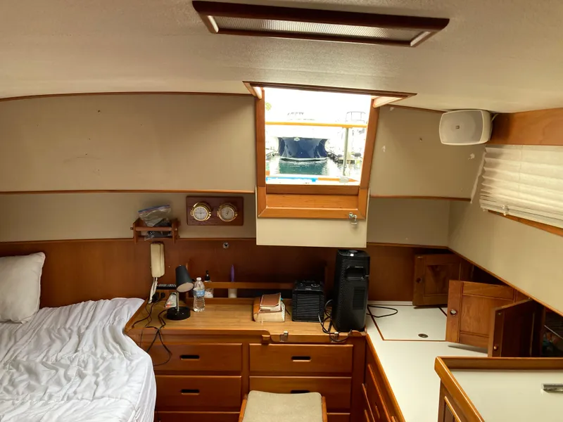Slide: The Image of Interior of 1985 Grand Banks 42 Classic yacht cabin with bed, desk, and window. - 22