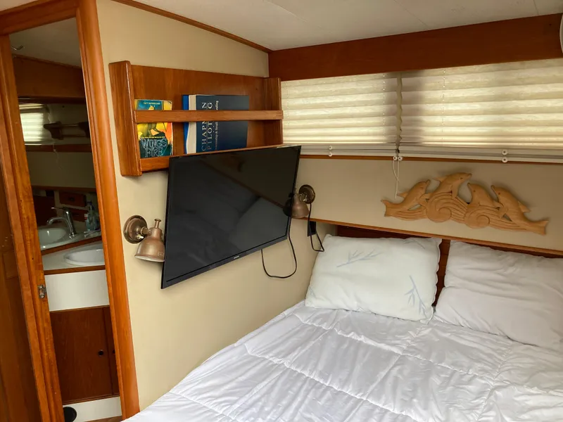 Slide: The Image of Cozy bedroom in 1985 Grand Banks 42 Classic yacht with TV and nautical decor. - 23