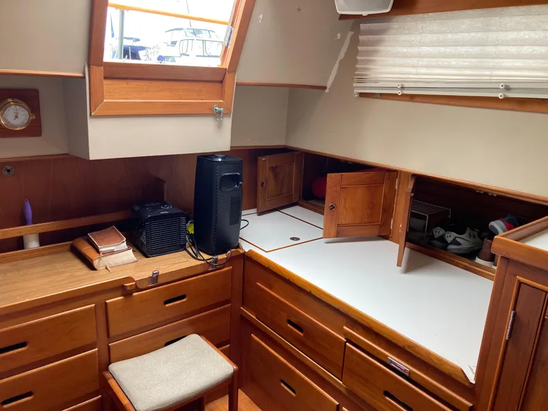 Slide: The Image of 1985 Grand Banks 42 Classic interior with wooden cabinetry and desk area. - 25