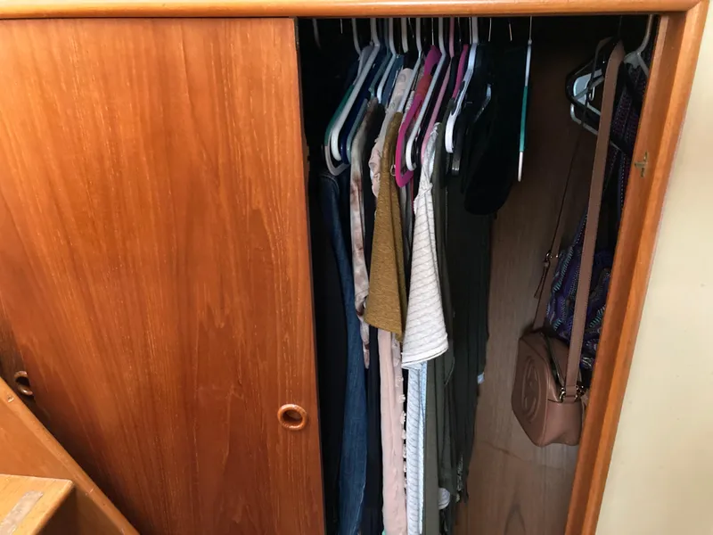 Slide: The Image of Wooden closet with clothes and bags inside, aboard a 1985 Grand Banks 42 Classic yacht. - 26