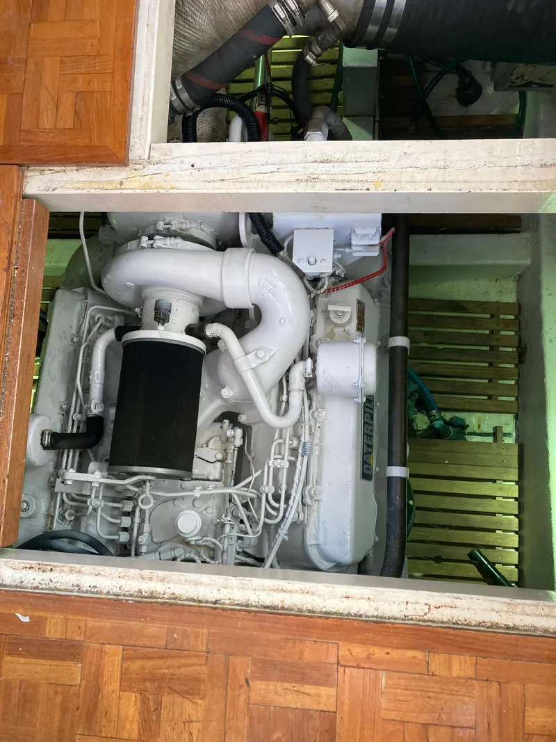 Slide: The Image of Engine compartment of a 1985 Grand Banks 42 Classic yacht, showcasing detailed machinery. - 33