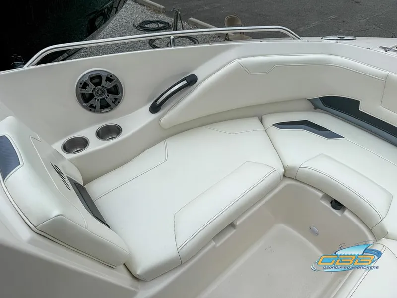 Slide: The Image of 2014 Monterey 244FS boat interior with white seating, cup holders, and speaker. - 10
