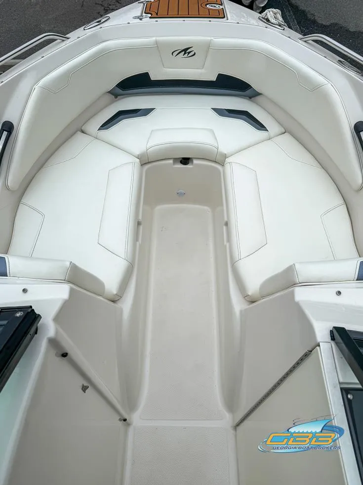 Slide: The Image of 2014 Monterey 244FS boat interior with white seating and logo. - 11
