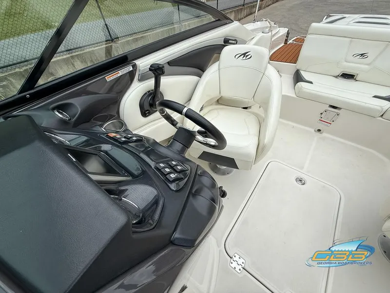 Slide: The Image of 2014 Monterey 244FS boat interior with steering wheel and seating area. - 12