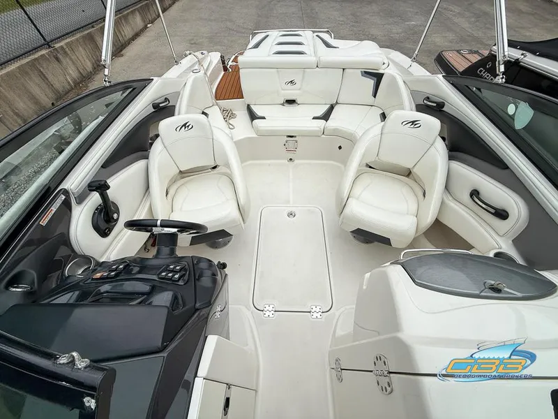 Slide: The Image of 2014 Monterey 244FS boat interior with white seating and control panel. - 13