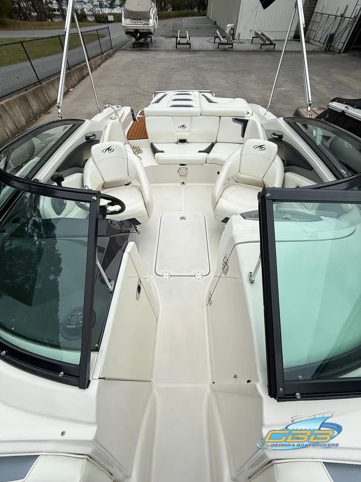 Slide: The Image of 2014 Monterey 244FS boat interior with white seating and open deck layout. - 14
