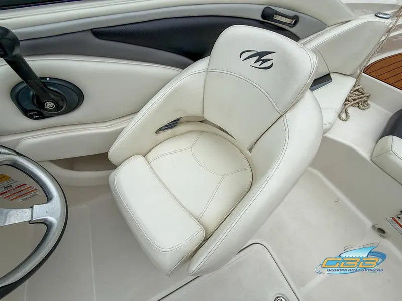 Slide: The Image of 2014 Monterey 244FS boat interior with white captain's seat and steering wheel. - 17