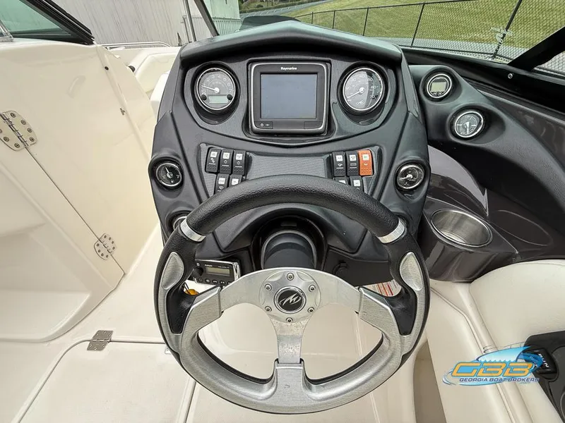 Slide: The Image of 2014 Monterey 244FS boat dashboard with steering wheel and control panel. - 18