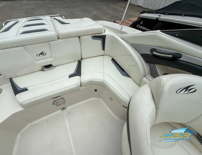 Slide: The Image of 2014 Monterey 244FS boat interior with white leather seating and logo detailing. - 20