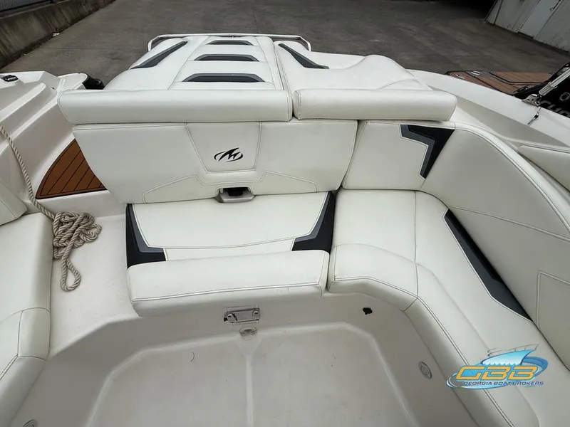Slide: The Image of 2014 Monterey 244FS boat interior with white leather seating and logo. - 23