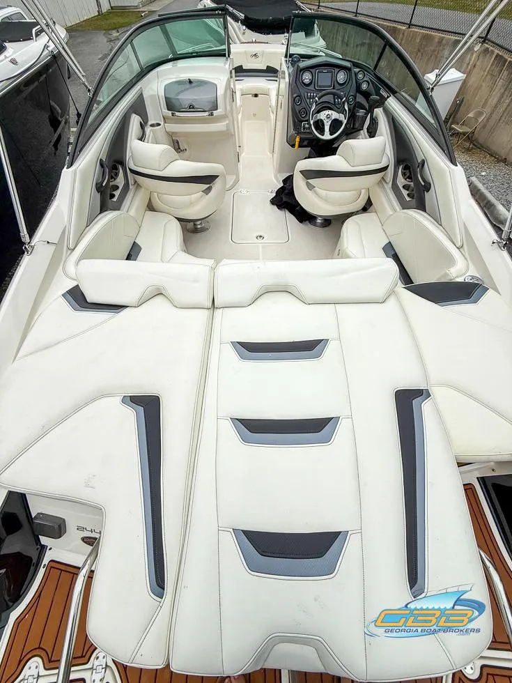 Slide: The Image of 2014 Monterey 244FS boat interior with white seating and modern dashboard. - 26