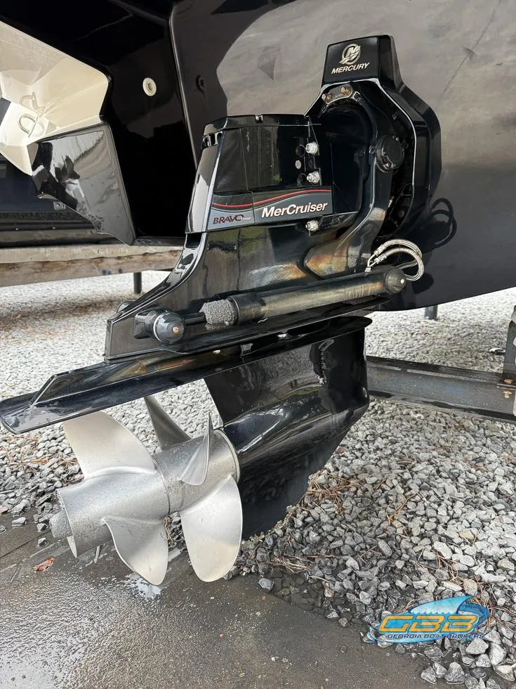 Slide: The Image of 2014 Monterey 244FS boat with MerCruiser engine and propeller, displayed on gravel surface. - 28