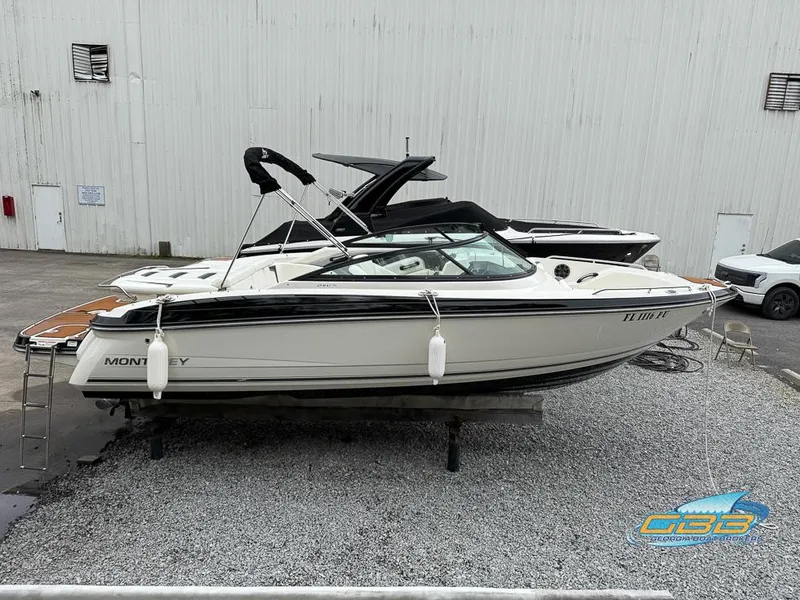 Slide: The Image of 2014 Monterey 244FS boat on display in a marina setting. - 4