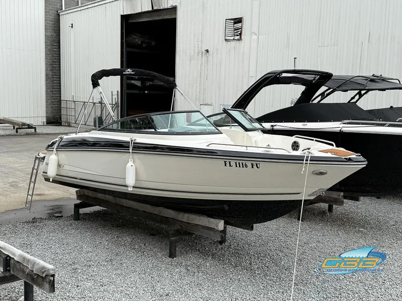 Slide: The Image of 2014 Monterey 244FS boat on display in a marina setting. - 5