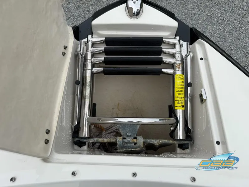 Slide: The Image of 2014 Monterey 244FS boat ladder compartment with folded stainless steel ladder. - 7