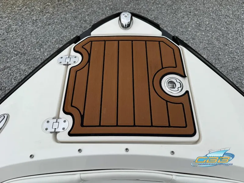 Slide: The Image of 2014 Monterey 244FS boat deck with wood finish and metal hinges. - 8