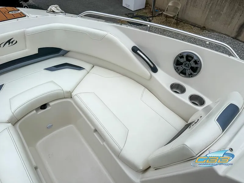 Slide: The Image of 2014 Monterey 244FS boat interior with white seating, cup holders, and speaker. - 9