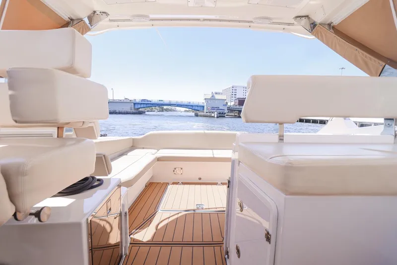 Slide: The Image of Interior view of 2016 Pursuit SC 365i yacht with waterfront backdrop. - 11