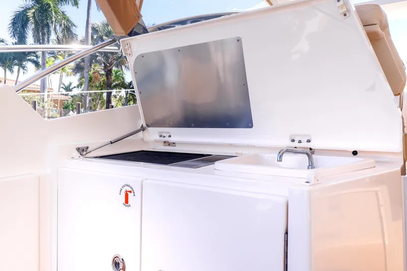 Slide: The Image of 2016 Pursuit SC 365i yacht outdoor kitchen with grill and sink. - 13