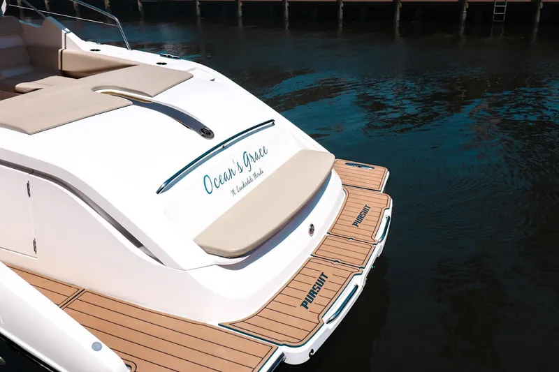 Slide: The Image of 2016 Pursuit SC 365i yacht with teak deck, docked on calm water. - 3