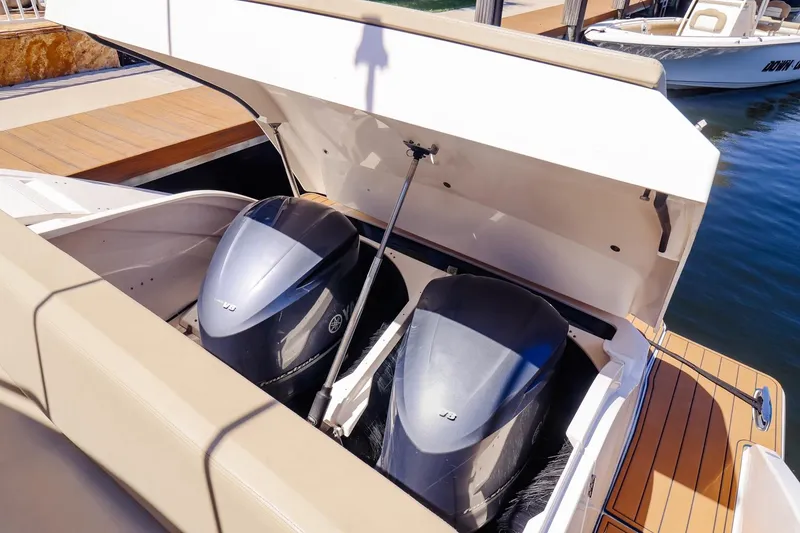 Slide: The Image of 2016 Pursuit SC 365i boat with open engine compartment, showcasing dual outboard motors. - 4