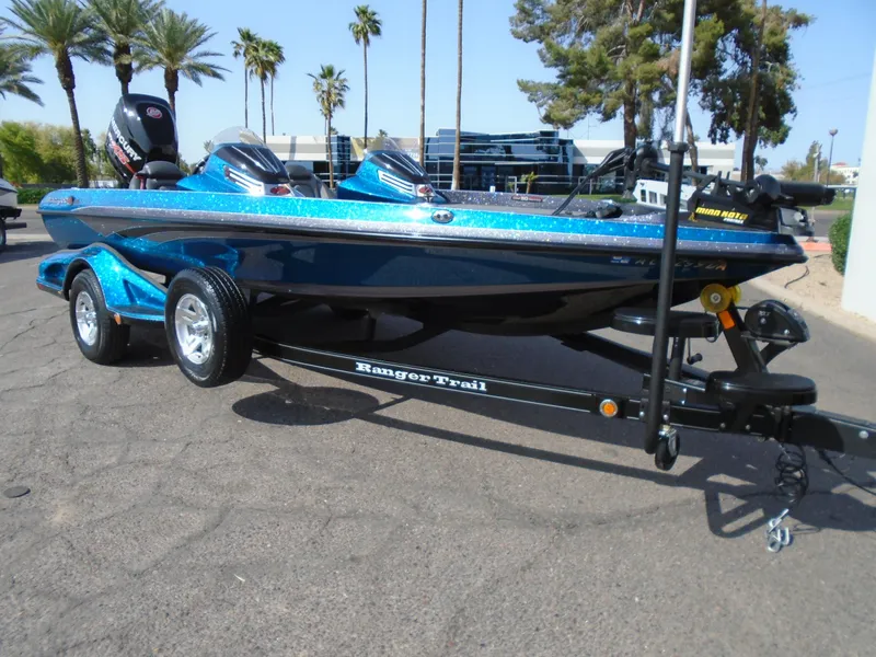 The Image of 2018 Ranger Z518 Comanche boat on trailer, parked outdoors with palm trees in the background. - 1