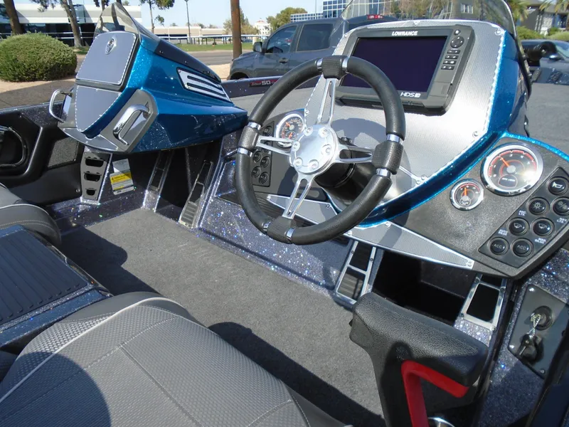 Slide: The Image of 2018 Ranger Z518 Comanche boat cockpit with steering wheel and control panel. - 16