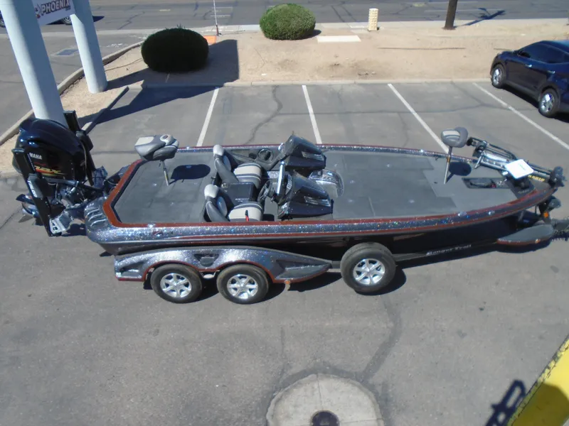 Slide: The Image of 2015 Ranger Z521 Comanche bass boat parked in a lot, side view. - 10