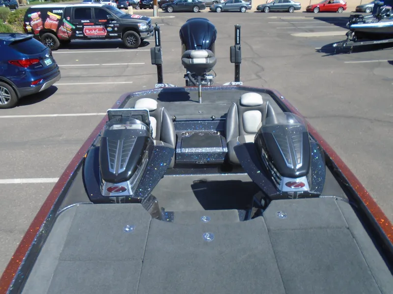 Slide: The Image of 2015 Ranger Z521 Comanche bass boat in a parking lot, showcasing seating and deck layout. - 11