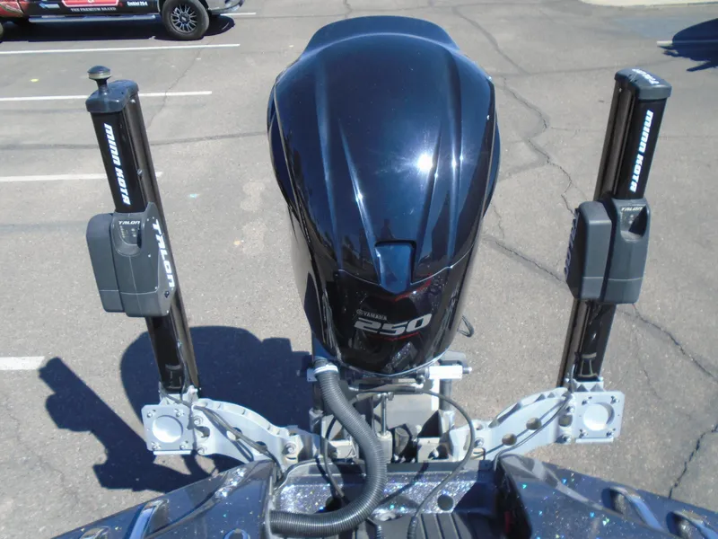 Slide: The Image of 2015 Ranger Z521 Comanche boat engine and power poles in a parking lot. - 12