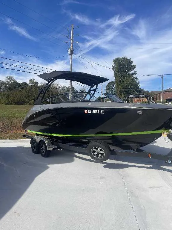 Slide: The Image of 2021 Yamaha Boats 255X on trailer under clear blue sky. - 15