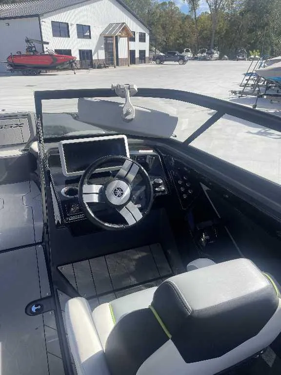 Slide: The Image of Interior view of 2021 Yamaha Boats 255X, featuring steering wheel and dashboard controls. - 8