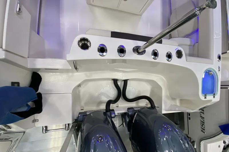 Slide: The Image of 2024 Sailfish 242 CC boat stern with dual engines and fishing rod holders. - 11