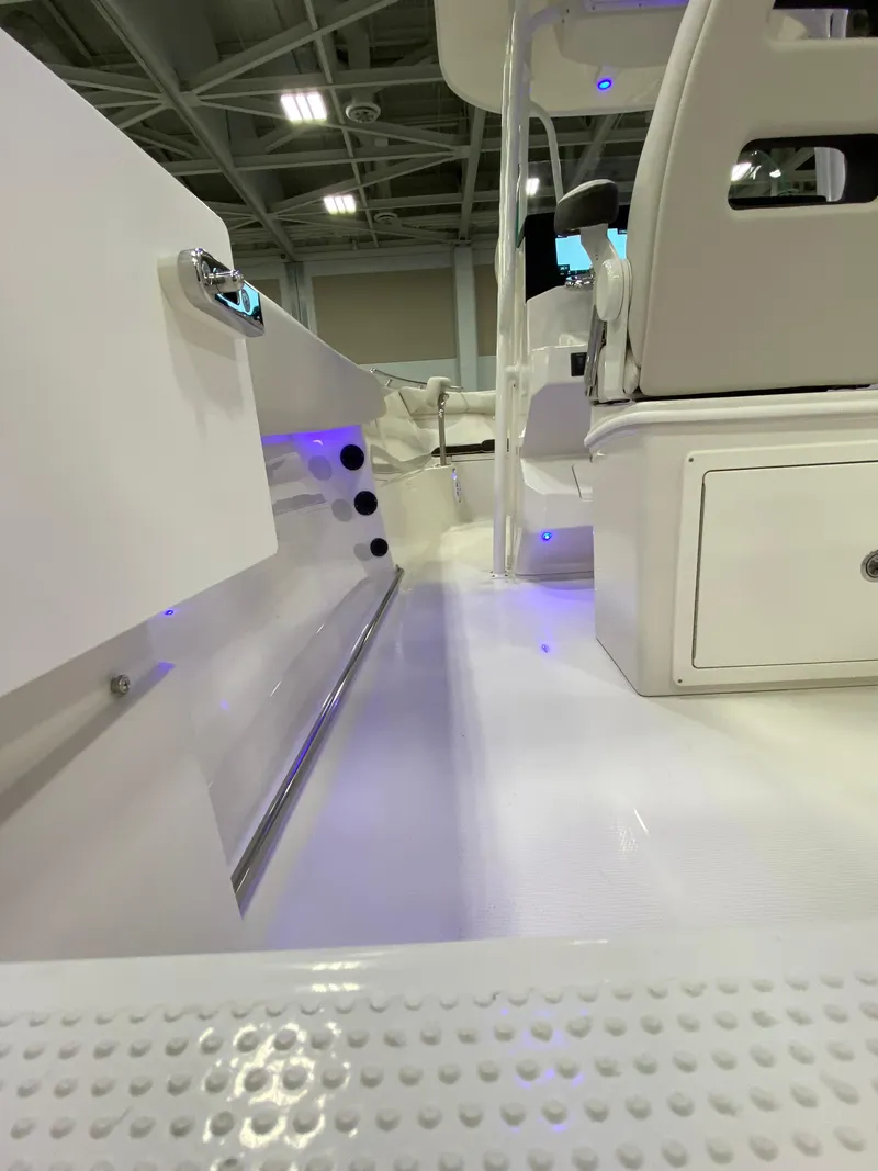 Slide: The Image of 2024 Sailfish 242 CC boat interior with white seating and modern design. - 13