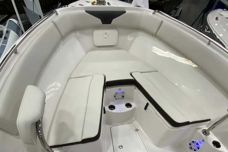 Slide: The Image of 2024 Sailfish 242 CC boat interior with white cushioned seating and modern design. - 2