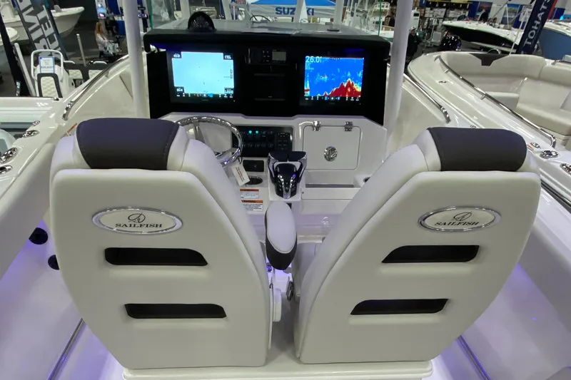 Slide: The Image of 2024 Sailfish 242 CC boat cockpit with dual seats and advanced navigation displays. - 3