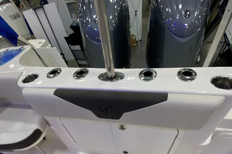 Slide: The Image of 2024 Sailfish 242 CC boat interior with rod holders and storage compartments. - 8