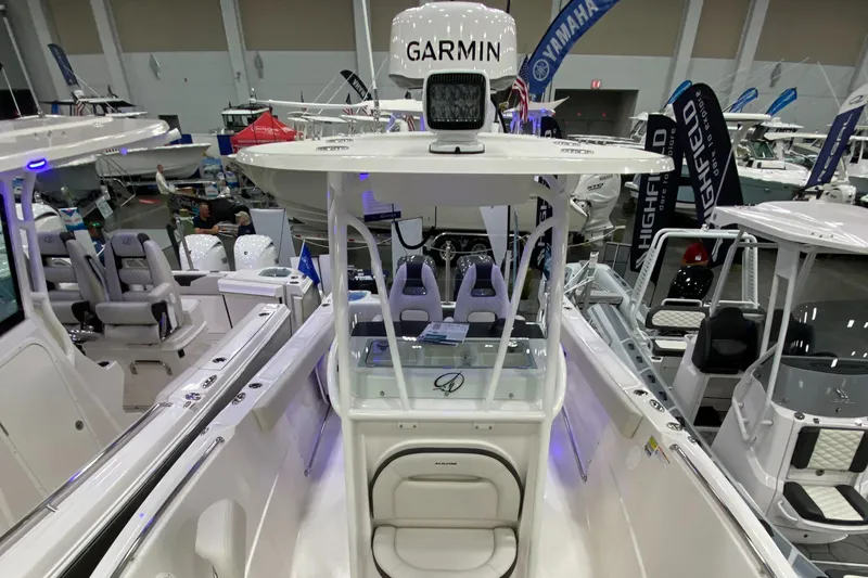 Slide: The Image of 2024 Sailfish 242 CC boat with Garmin equipment at a boat show. - 9