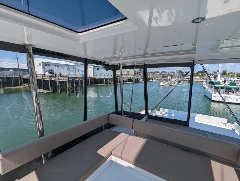 Slide: The Image of Interior view of 2022 Bali 4.6 catamaran with waterfront marina backdrop. - 14