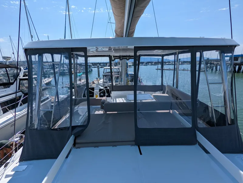 Slide: The Image of 2022 Bali 4.6 catamaran with enclosed cockpit, docked at marina. - 15