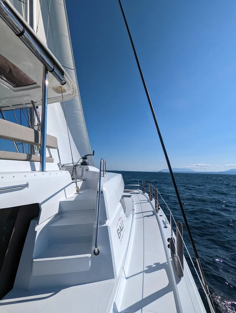 Slide: The Image of Sailing on a 2022 Bali 4.6 catamaran under clear blue skies. - 17