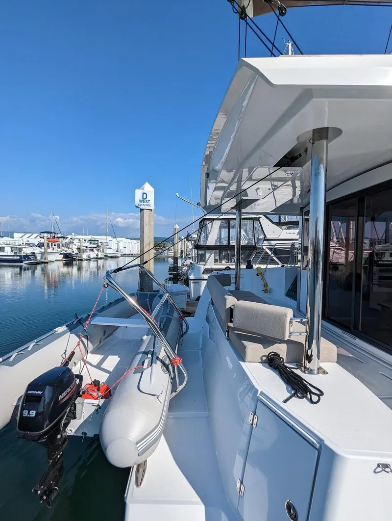 Slide: The Image of 2022 Bali 4.6 yacht docked at marina with inflatable boat. - 23