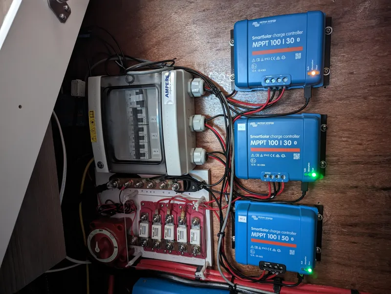 Slide: The Image of Electrical setup with three MPPT charge controllers and a fuse box in a Bali 4.6, 2022 model. - 28