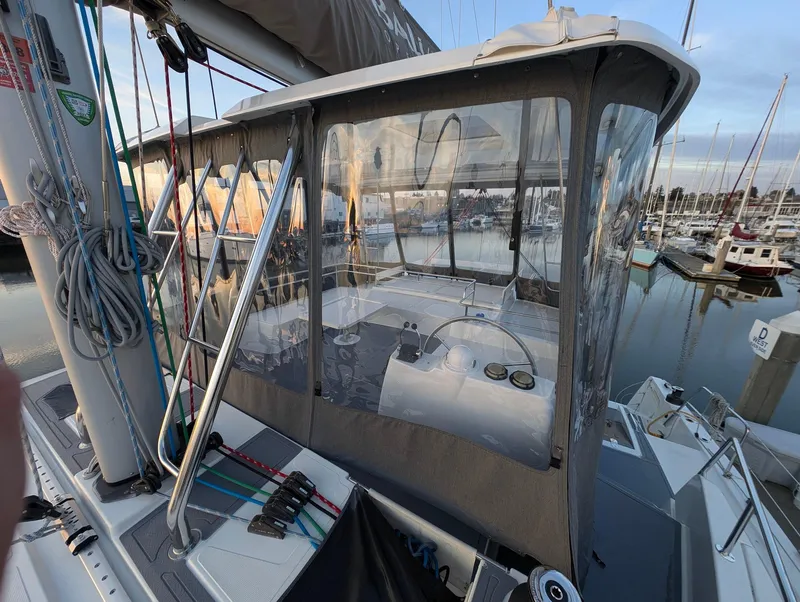 Slide: The Image of 2022 Bali 4.6 yacht cockpit with clear enclosure, docked at marina. - 38