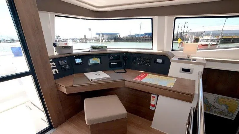 Slide: The Image of Interior of 2022 Bali 4.6 yacht cockpit with navigation equipment and harbor view. - 4