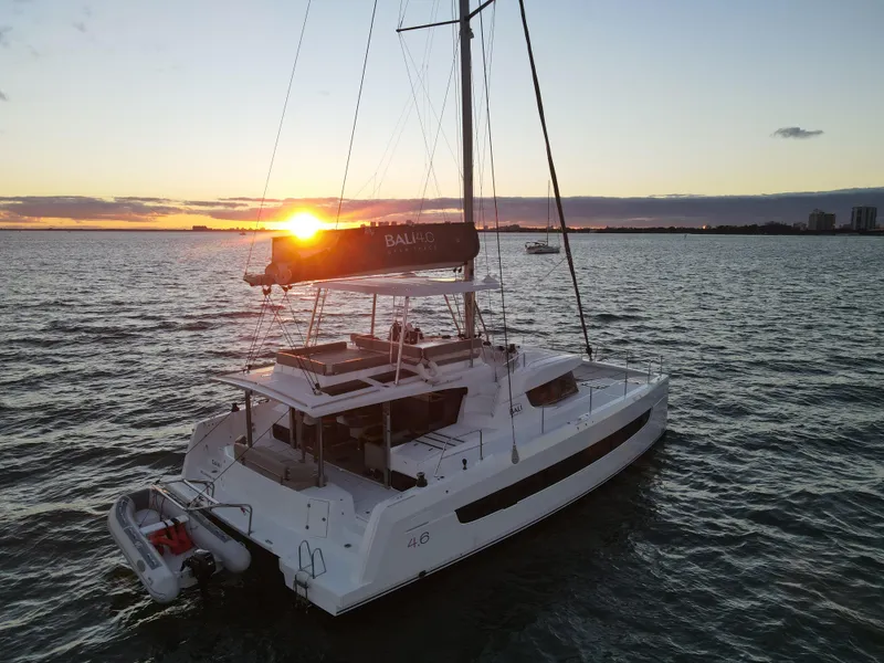 Slide: The Image of Bali 4.6 catamaran sailing at sunset, 2022 model, on open water. - 45