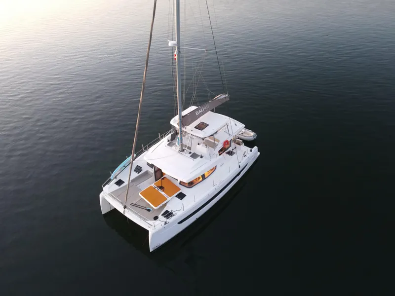 Slide: The Image of Aerial view of 2022 Bali 4.6 catamaran sailing on calm water. - 48