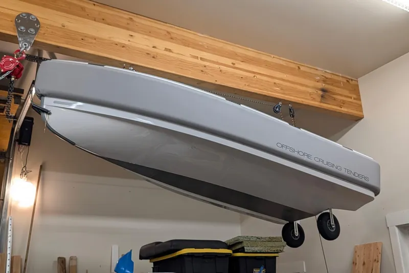 Slide: The Image of Hanging Bali 4.6 boat in garage, 2022 model, with wooden beams and storage items. - 66