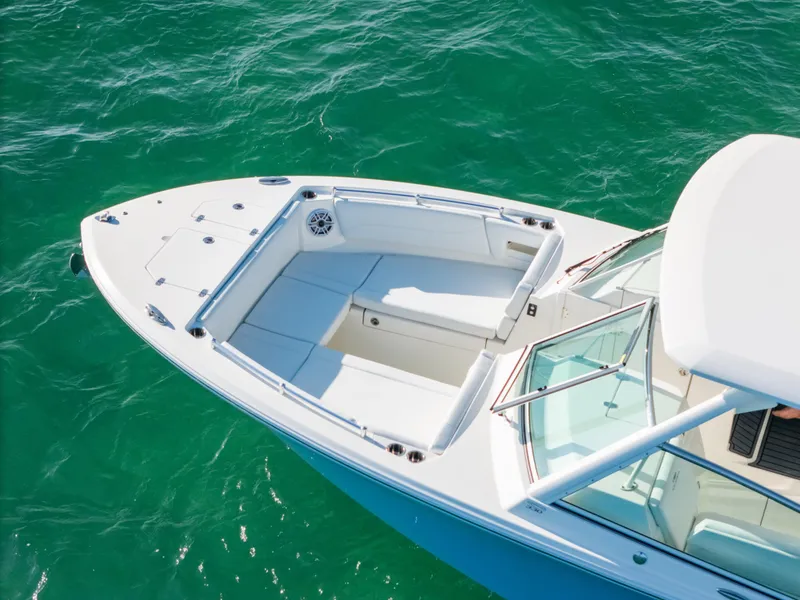Slide: The Image of 2024 Cobia 330 Dual Console boat on clear turquoise water. - 11